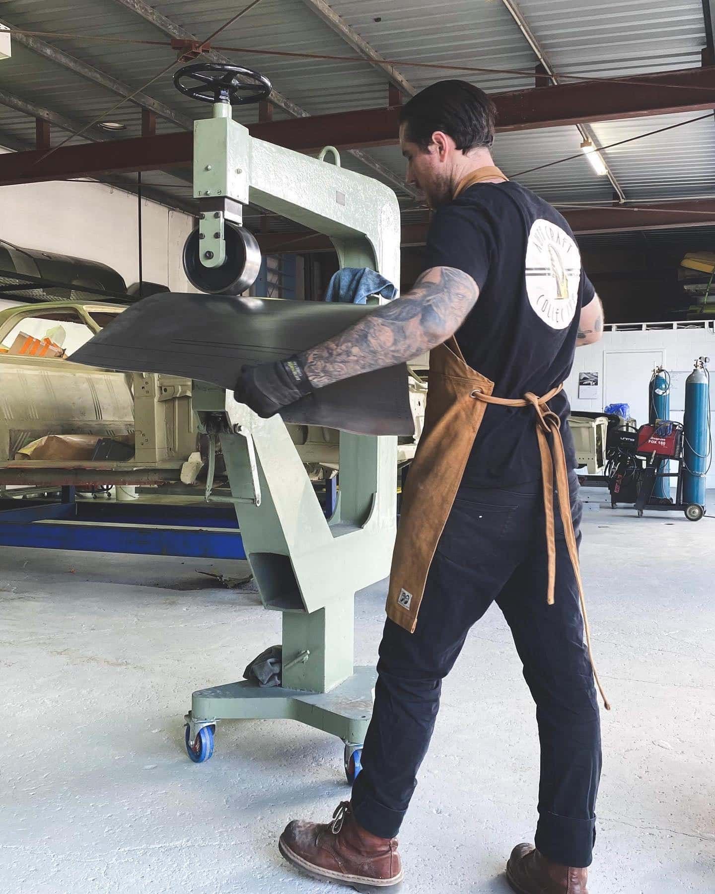 A Silver Car is Parked in a Garage Next to a Garage Door — Auto Craft Collective in Rockhampton, QLD