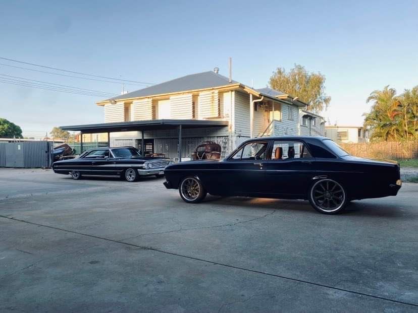 Two Black Cars are Parked in Front of a House — Auto Craft Collective in Rockhampton, QLD
