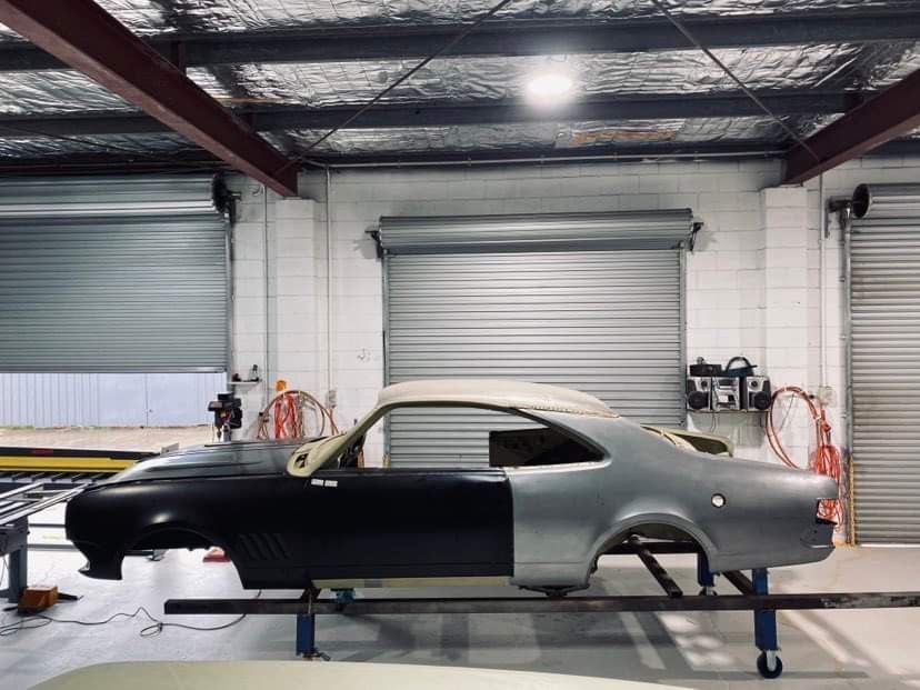 A Car is Being Painted in a Garage — Auto Craft Collective in Rockhampton, QLD