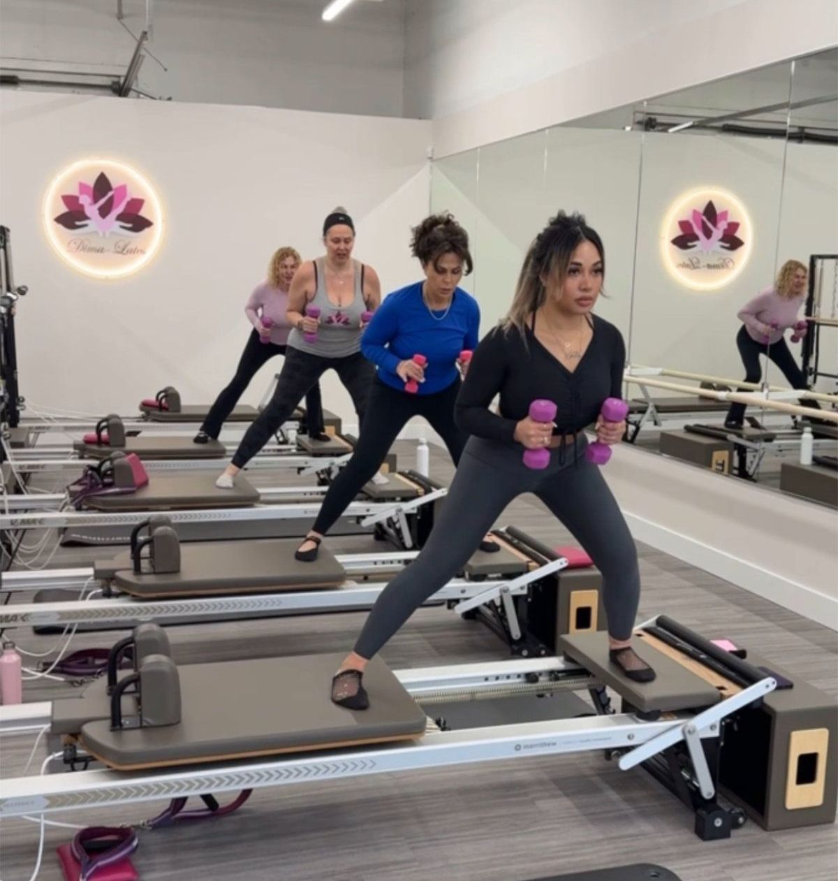A man and a woman are doing pilates in a gym