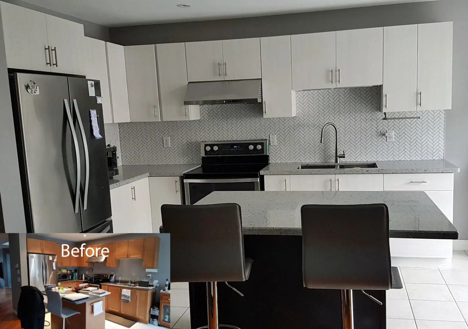 Modern white kitchen with stainless steel appliances and a black island with bar stools.