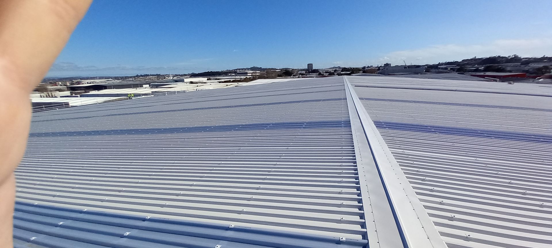A small house with a metal roof is lit up at night