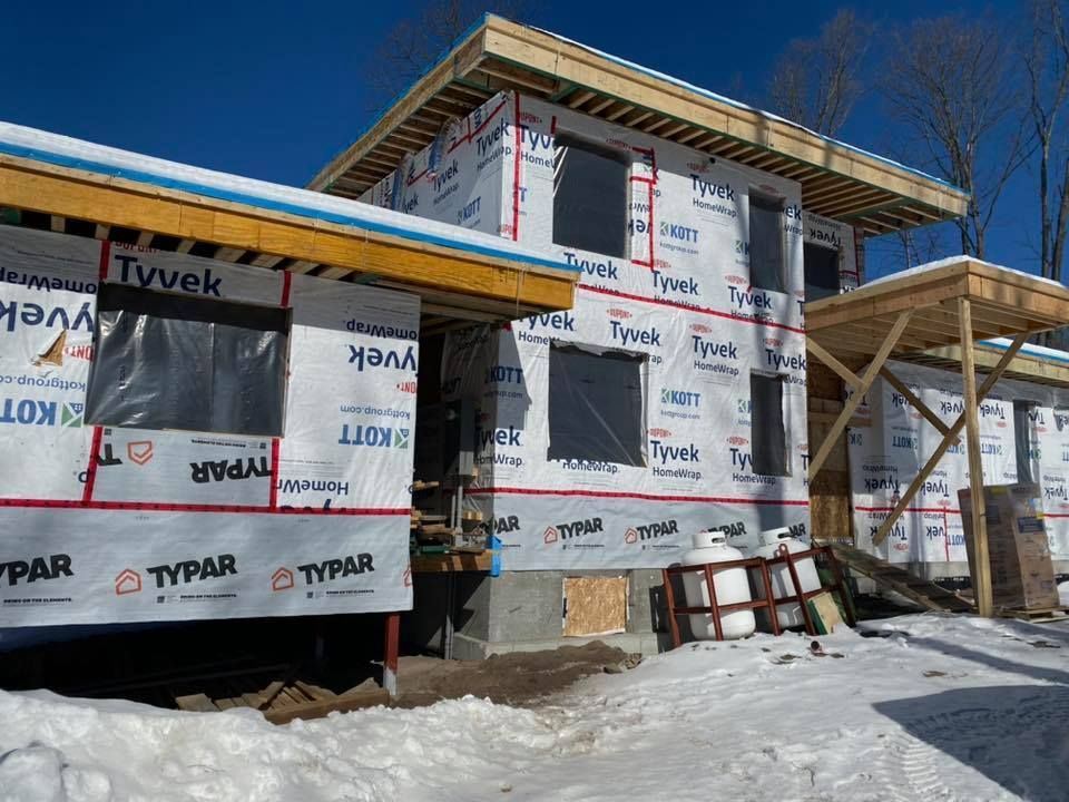A house is being built in the snow and is covered in styrofoam.