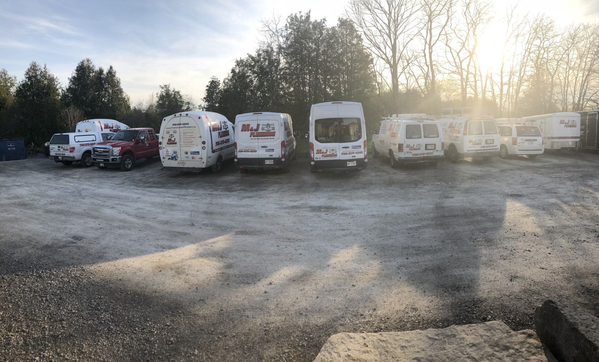 A lot of vans are parked in a parking lot
