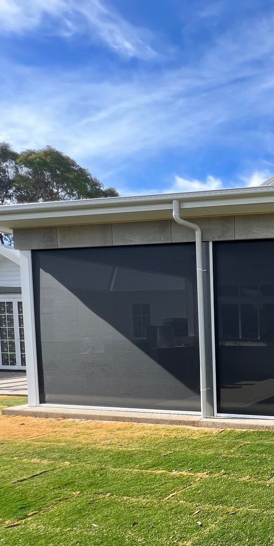Interior View Of A Room With A Sliding Glass Door And Blinds On The Windows — SG Glass & Aluminium in Wagga Wagga, NSW