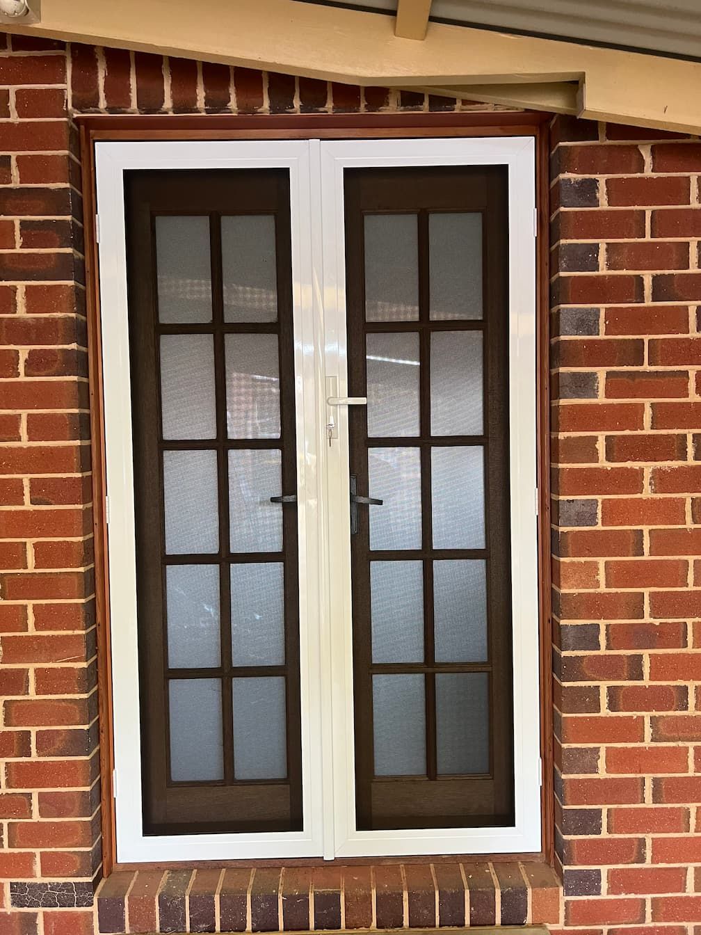 Brick Wall With A Window And A Screen Door — SG Glass & Aluminium in Wagga Wagga, NSW