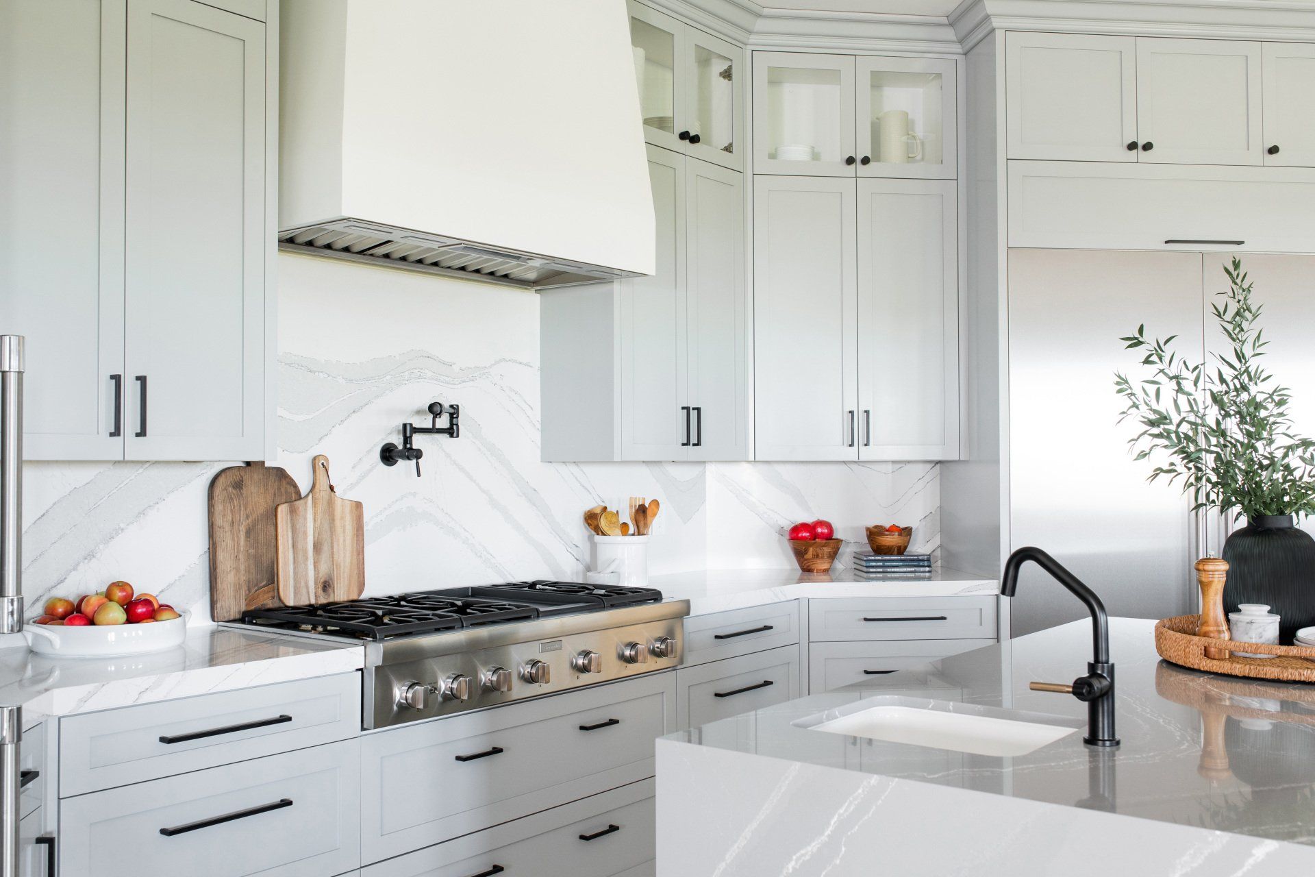 A kitchen with white cabinets and stainless steel appliances.