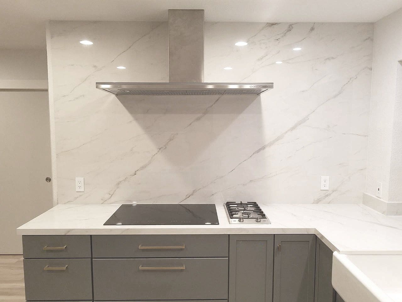 A kitchen with a stove top oven and a sink.