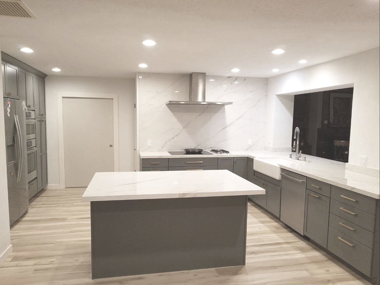 A kitchen with a large island in the middle of it.