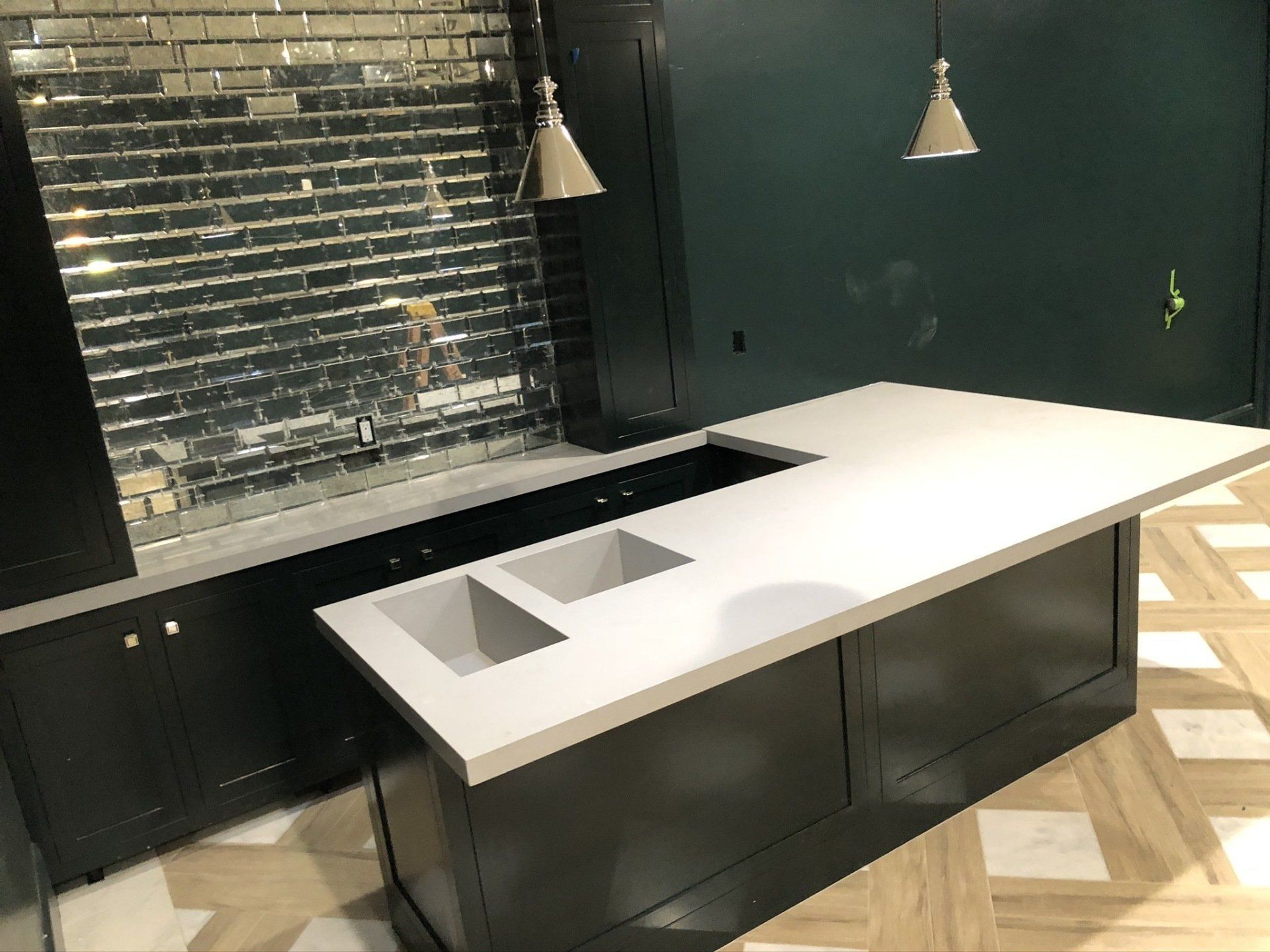 A kitchen with two sinks and a large counter top.