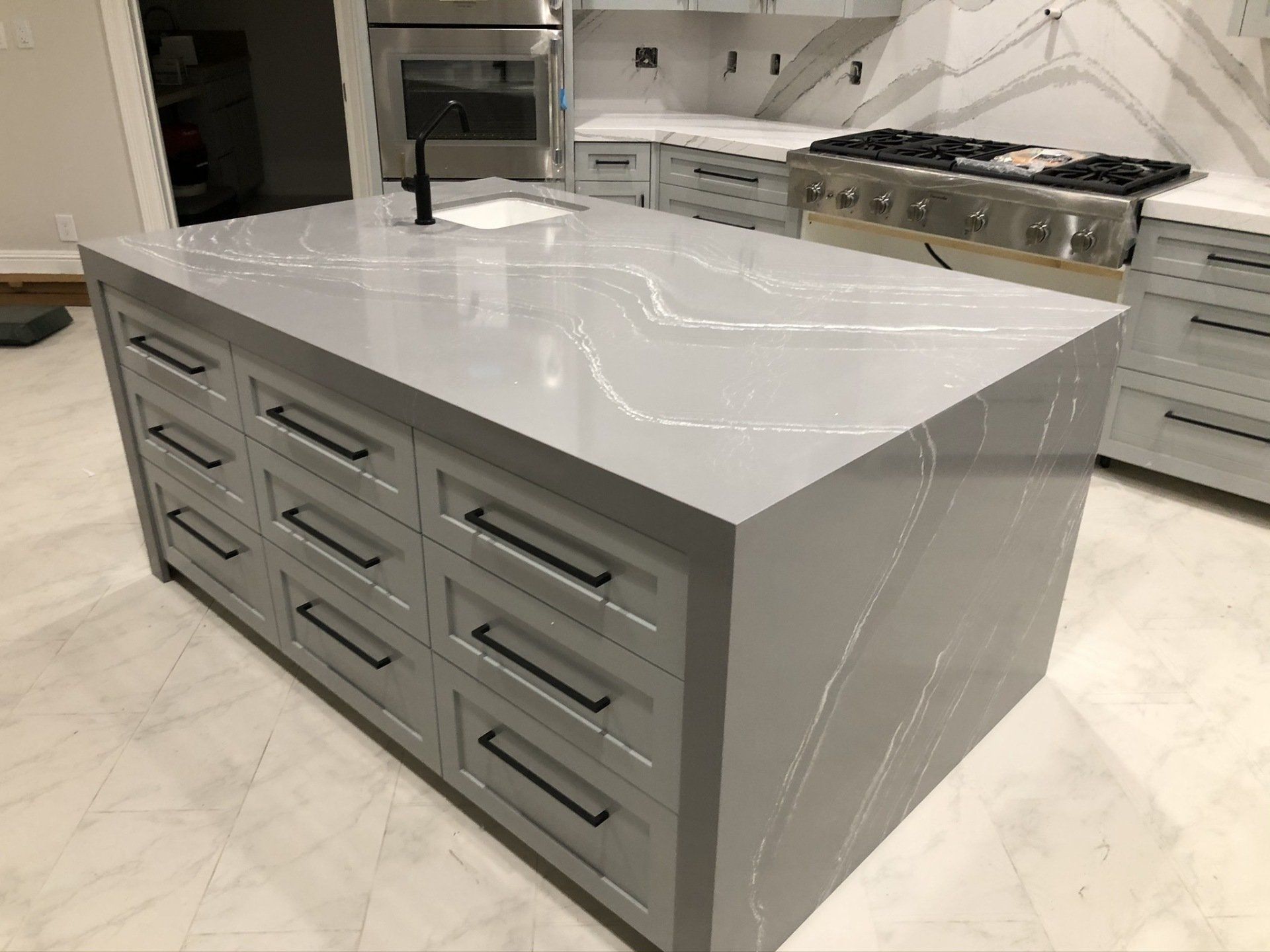 There is a large island in the middle of the kitchen.