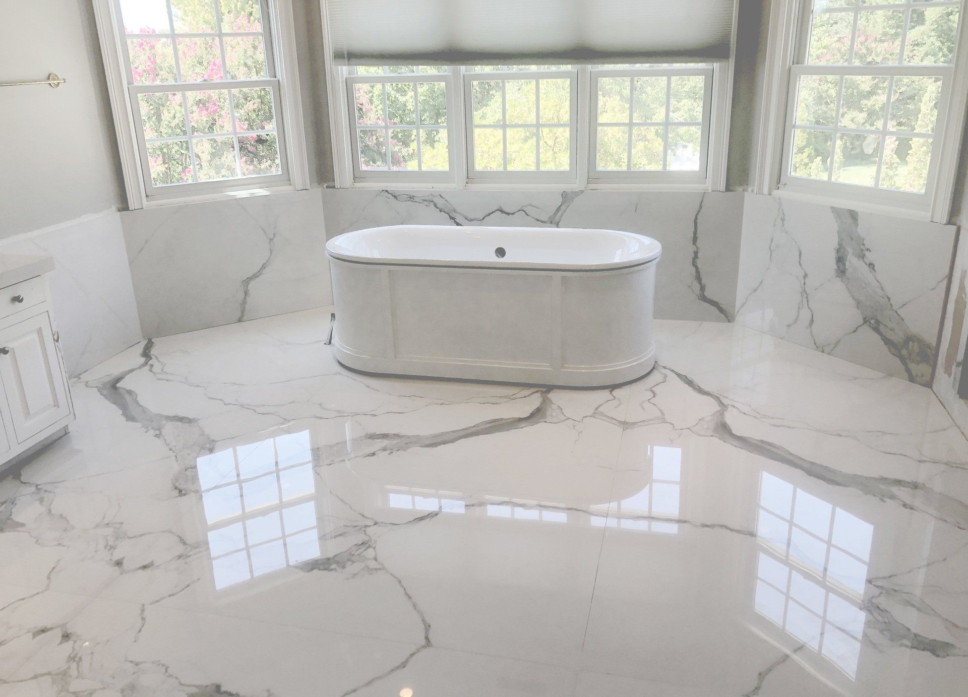 There is a bathtub in the middle of the bathroom.