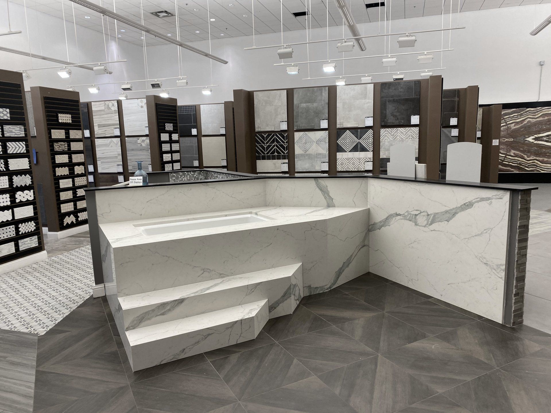 A 3d rendering of a bathroom showroom with a bathtub and stairs.