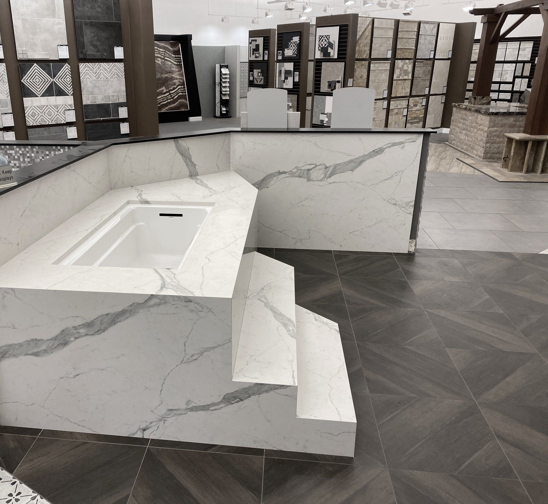 A bathroom with a sink and stairs leading up to it