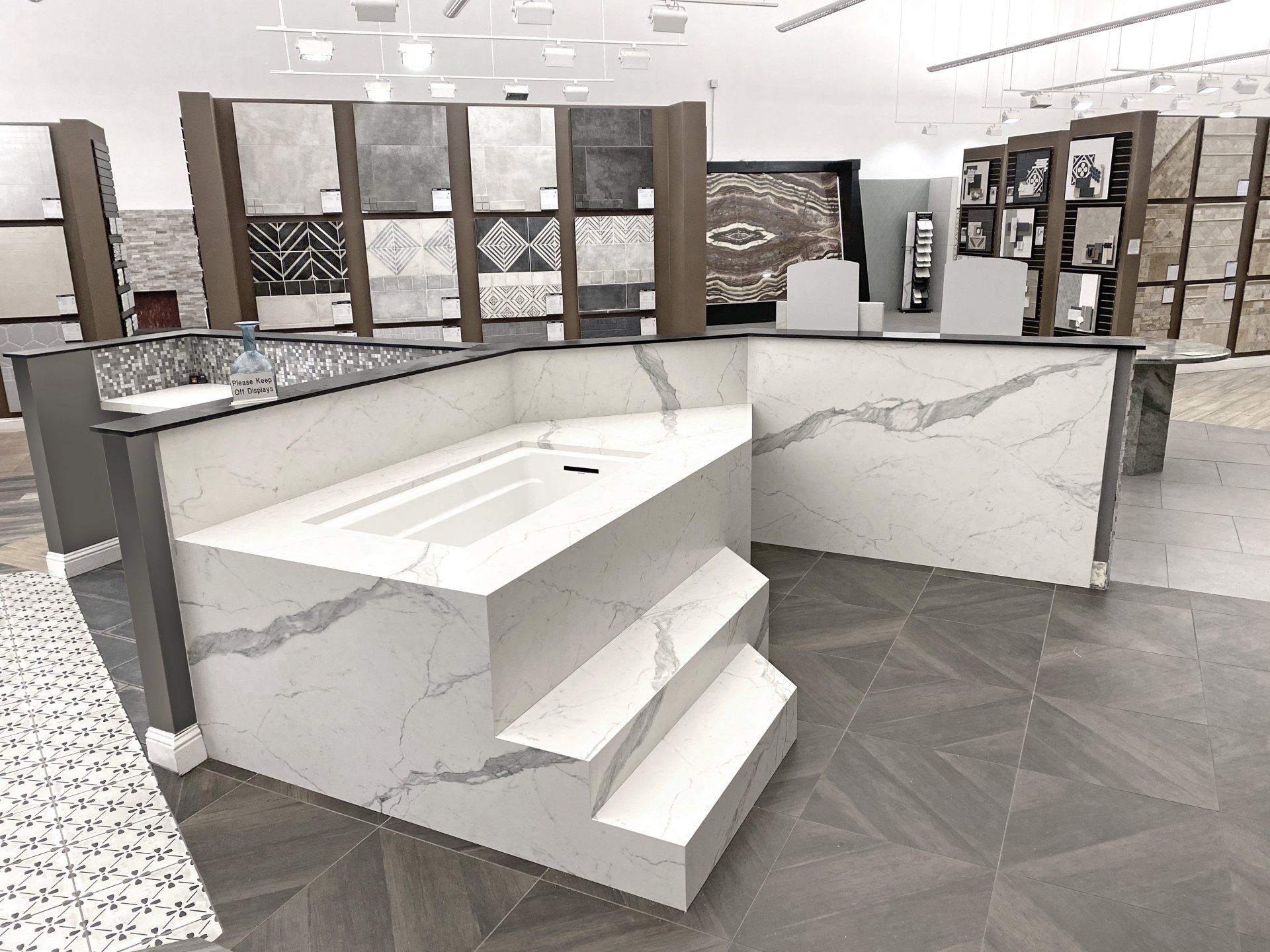 A bathroom with a bathtub and stairs in a showroom.