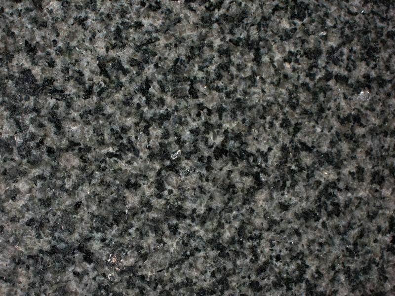 A close up of a black granite counter top.