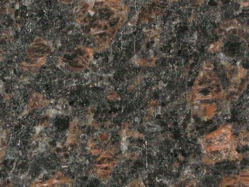 A close up of a brown and black granite counter top