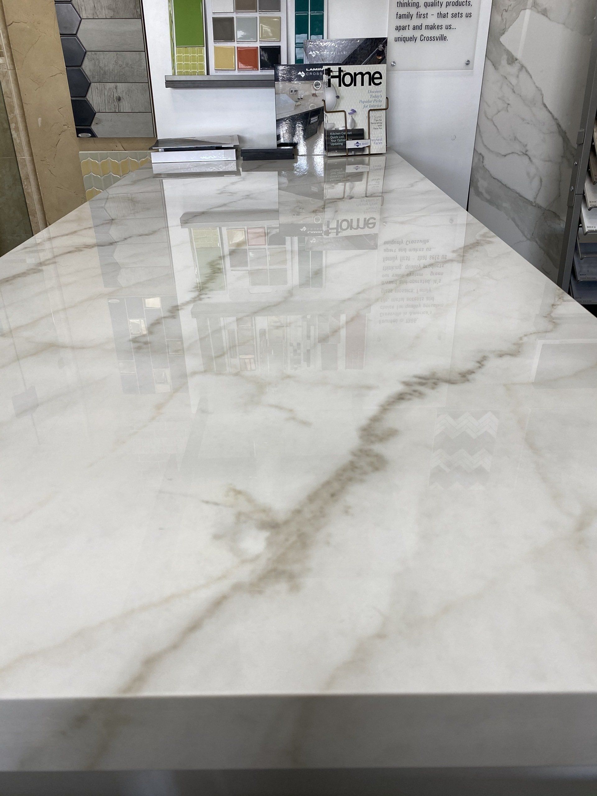 A white marble counter top is sitting in a room.