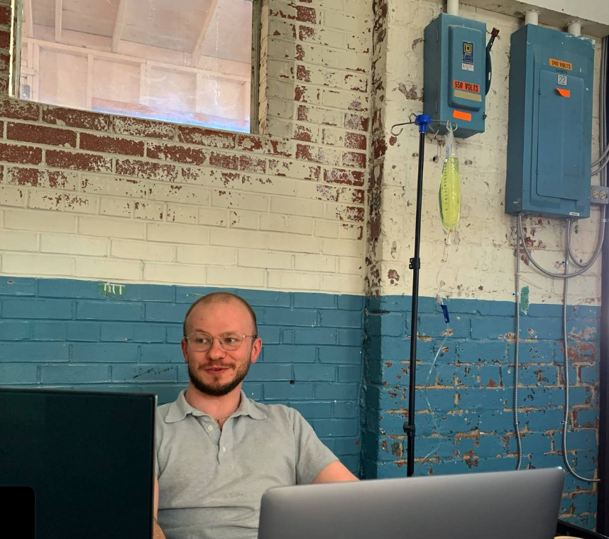 A man is sitting in front of a laptop computer