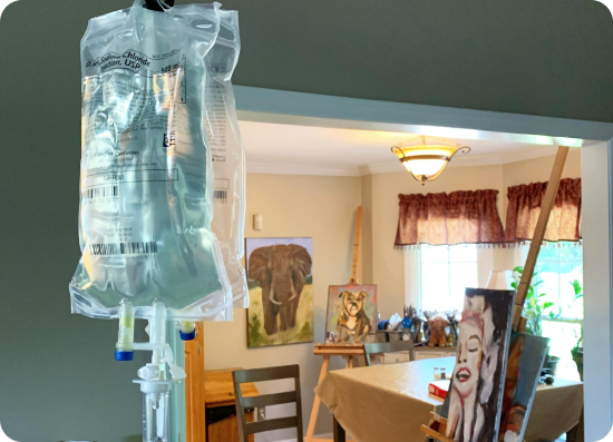 A bag of liquid is hanging from the ceiling in a room