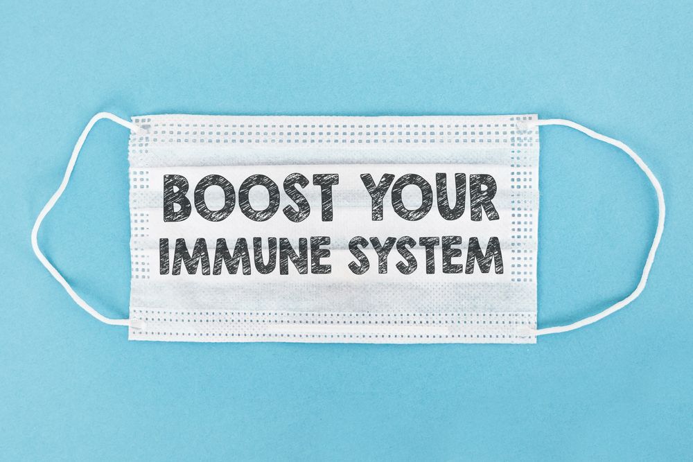 A face mask with the words `` boost your immune system '' written on it.