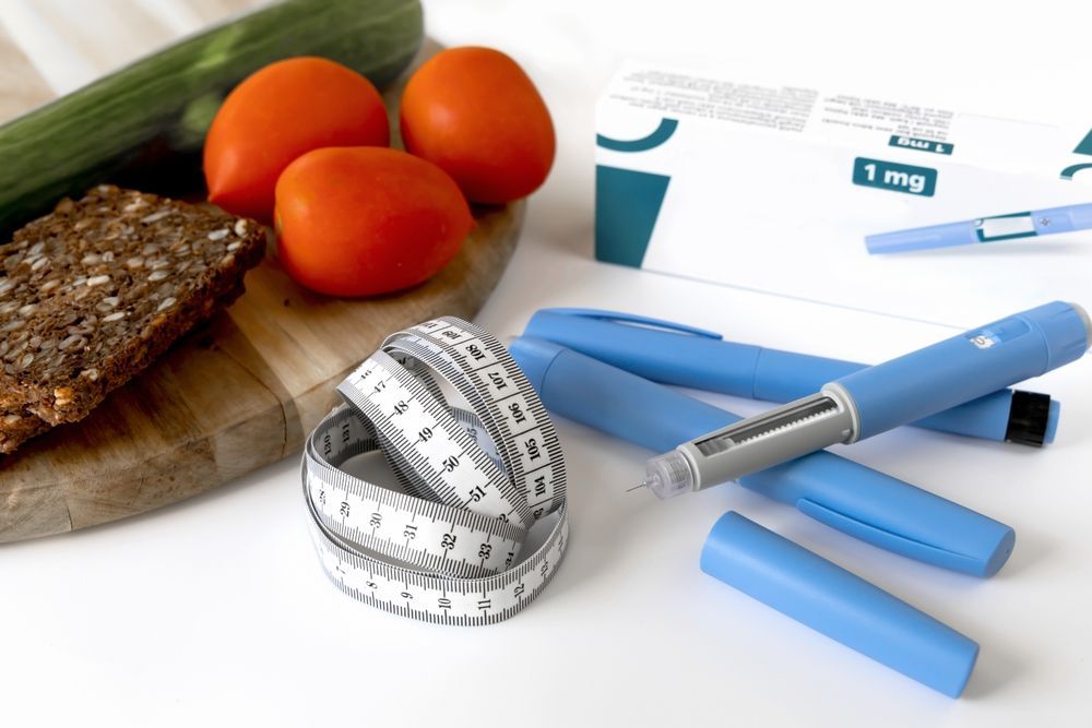 A cutting board with tomatoes bread and a measuring tape