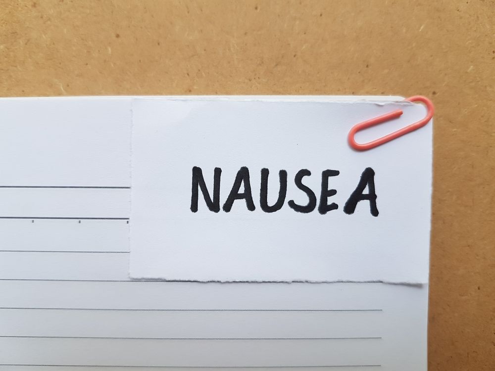 A piece of paper with the word nausea written on it