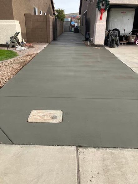 Newly poured concrete driveway between two houses.