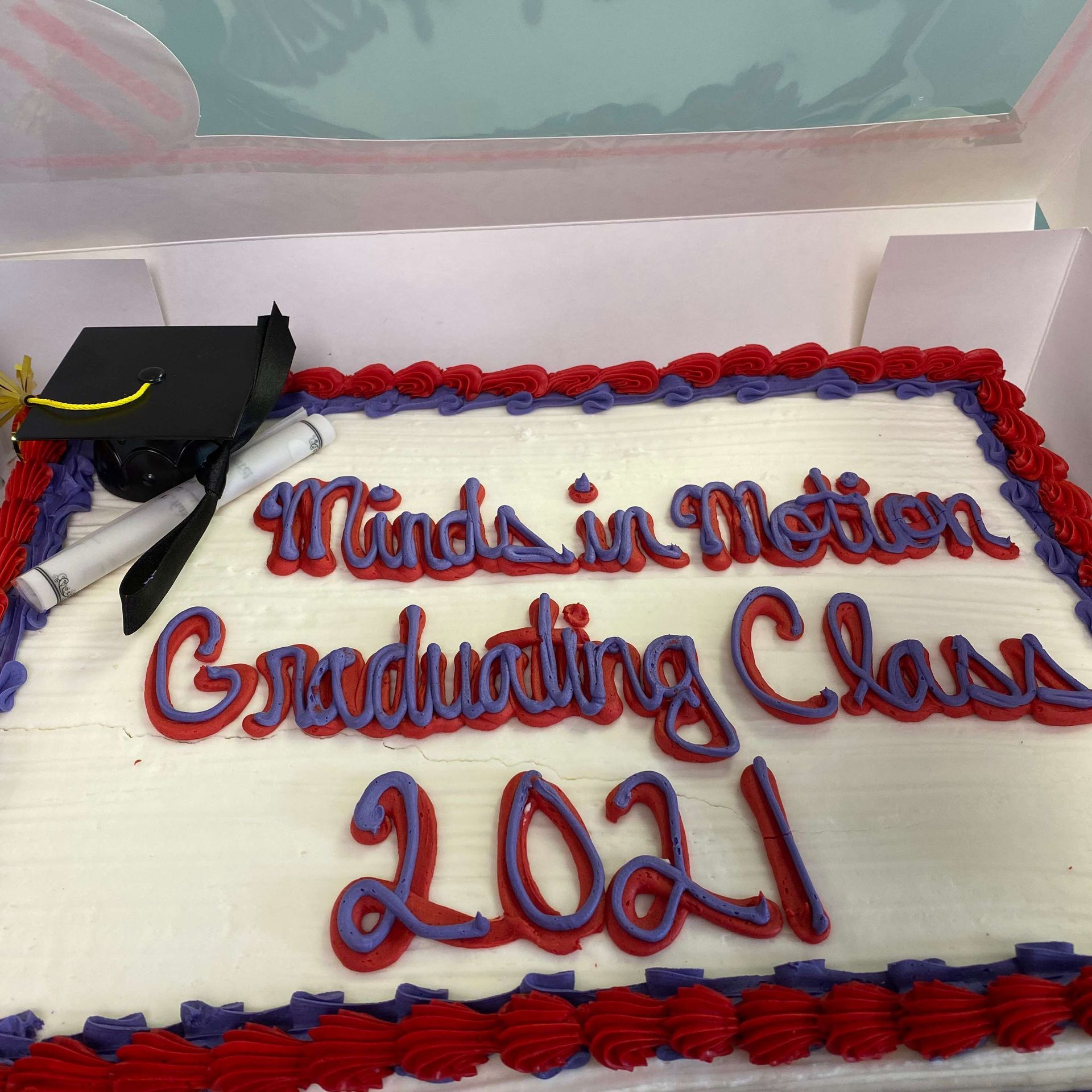 A cake that says made in motion graduation class 2021