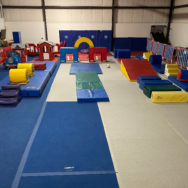 A gym filled with a bunch of mats and toys