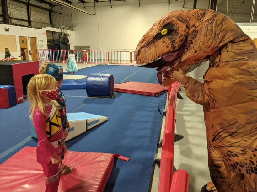 A Kid and a Dinosaur Mascot Inside the Indoor Playground