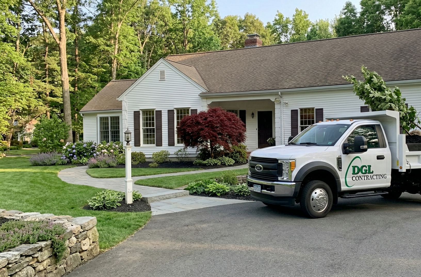 White service van parked outside a suburban house with a curved driveway and landscaped lawn