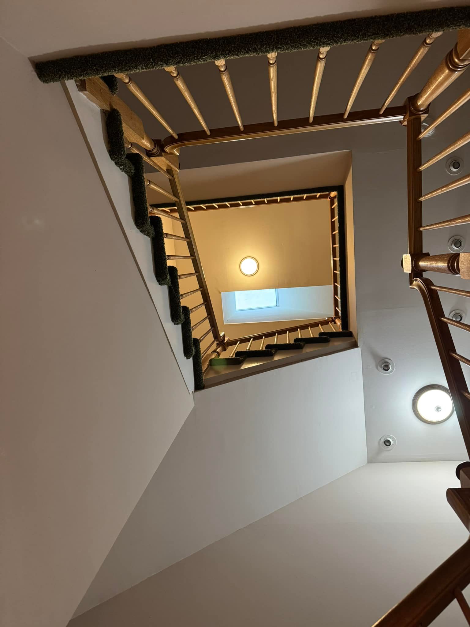 Looking up at a spiral staircase with a light on the ceiling
