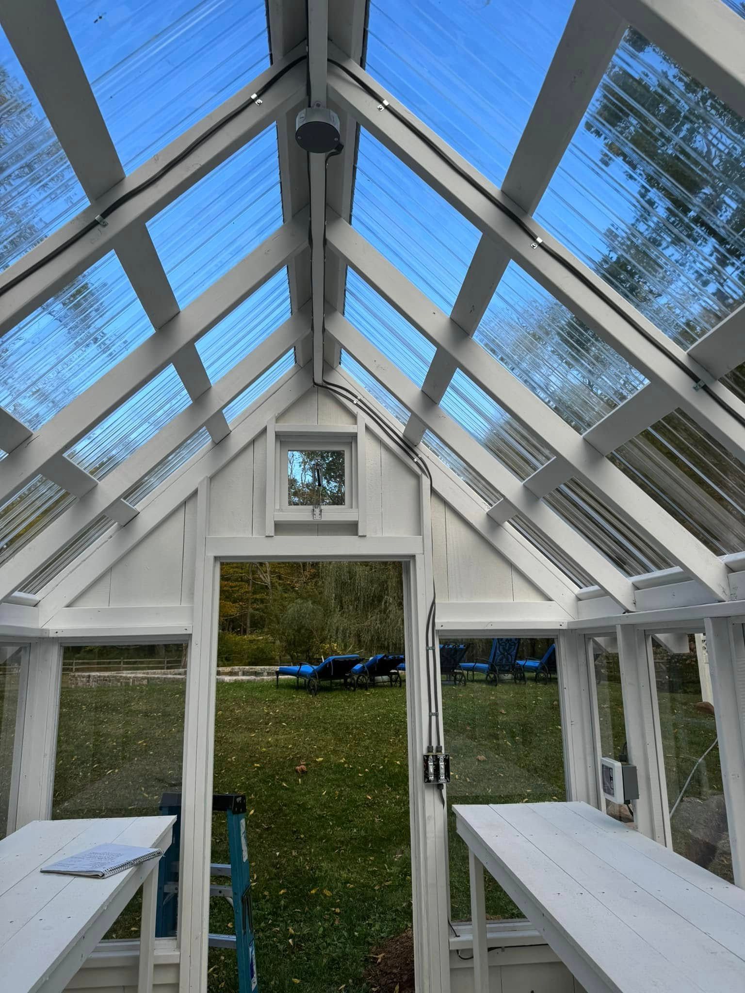 The inside of a greenhouse with a clear glass roof