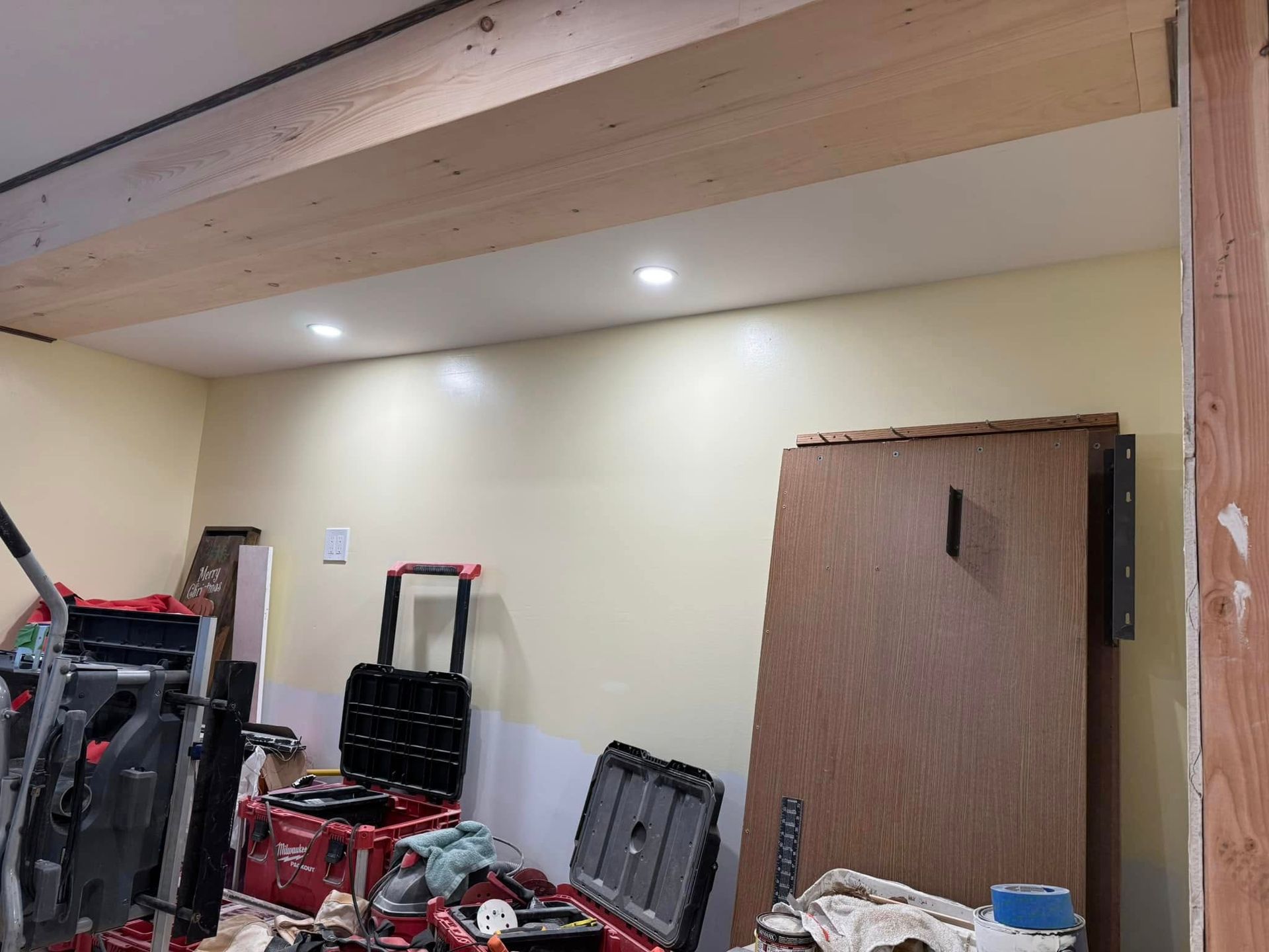 A room with a lot of tools in it and a wooden door.