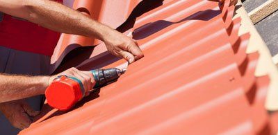 New Roof — Workers Installing Red Metal Tiles in Citrus County, FL