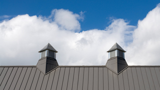 Roof Repair — Worker Replacing Gray Tiles in Citrus County, FL