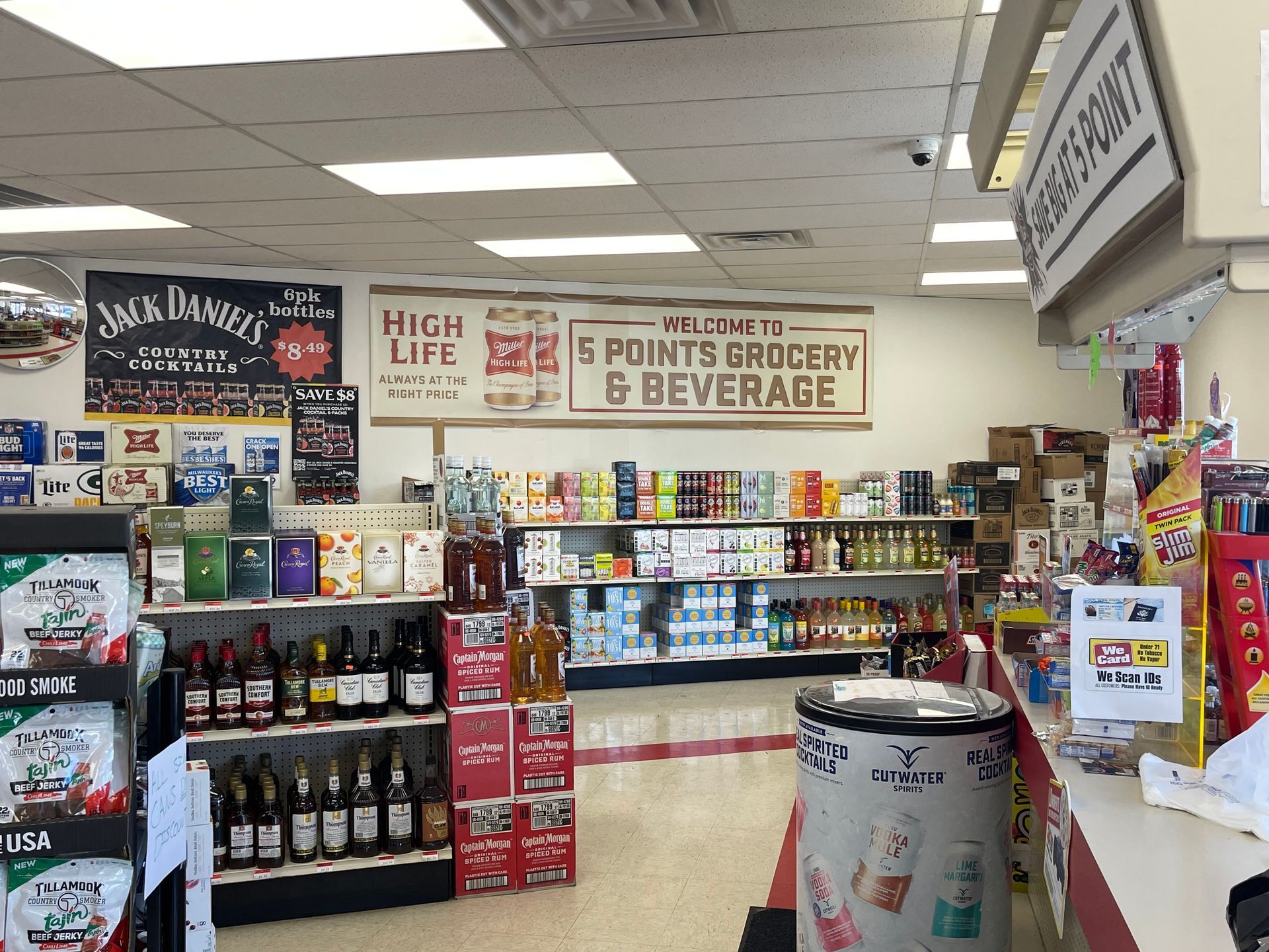 Interior of a convenience store, showcasing shelves of drinks and snacks.  Signage indicates "5 Points Grocery & Beverage".