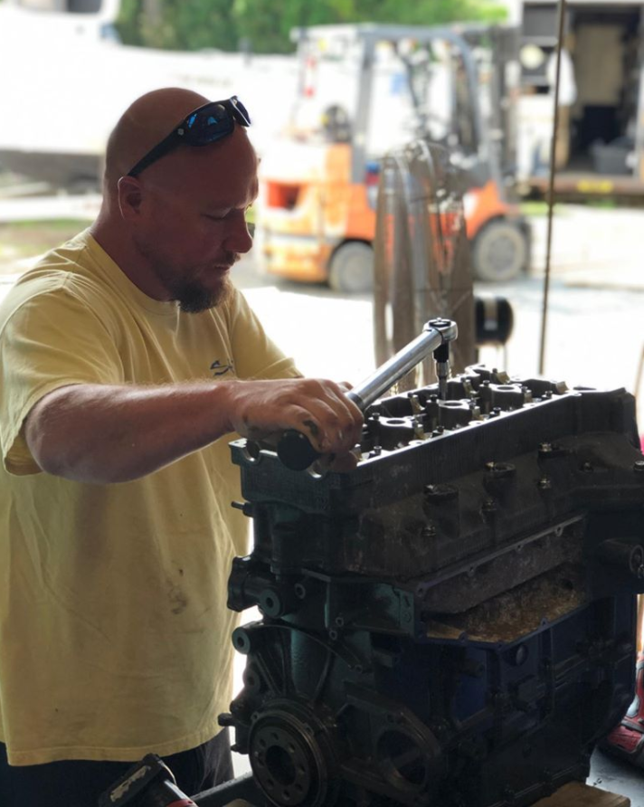 Man Repairing Boat Engine — Chesapeake, VA — Lancet Marine