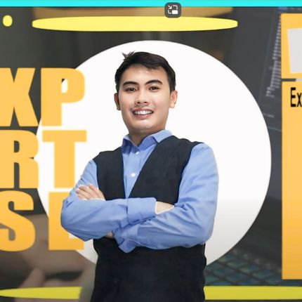 Smiling professional in a blue shirt and black vest posing confidently in front of a bold graphic background.