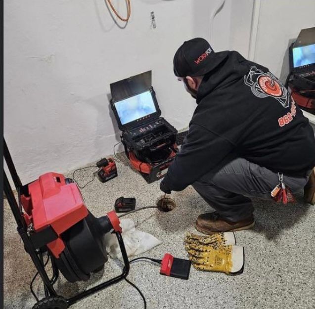 A man is kneeling down in front of a laptop that says video