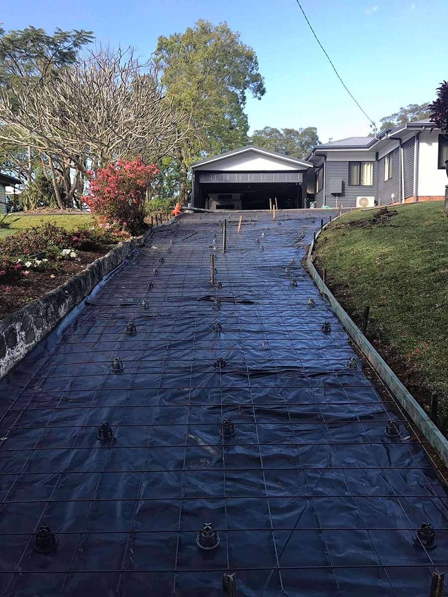 Concrete Driveway Is Being Built In Front Of A House — Providing Steel & Concrete Construction In Byron Bay, NSW