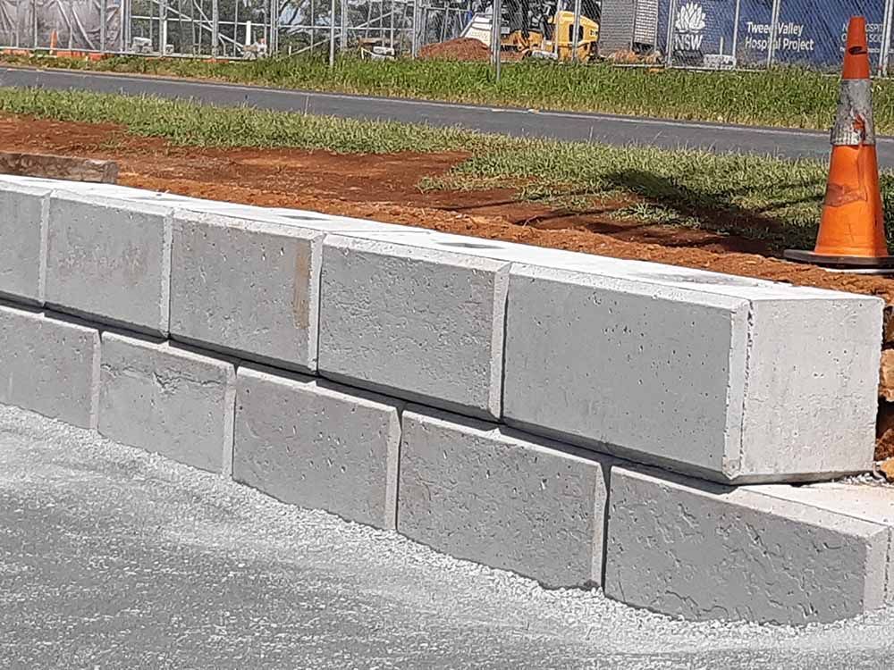 Concrete Wall Is Being Built Next To A Road — Providing Steel & Concrete Construction In Eviron, NSW