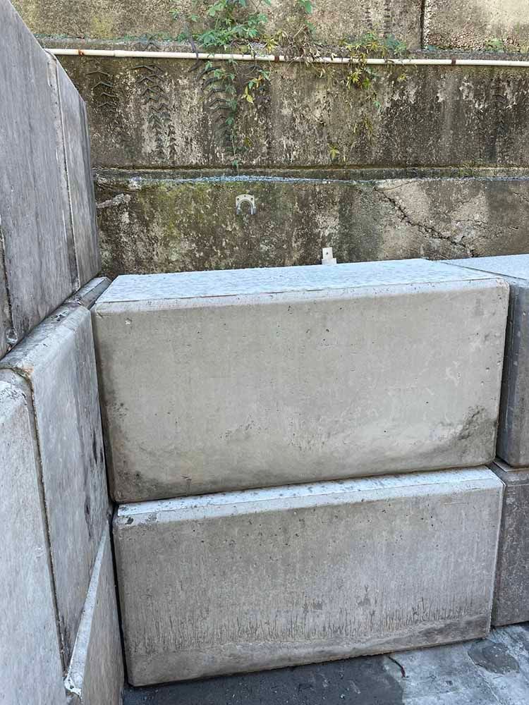 Pile Of Concrete Blocks Stacked On Top Of Each Other In Front Of A Wall — Providing Steel & Concrete Construction In Byron Bay, NSW