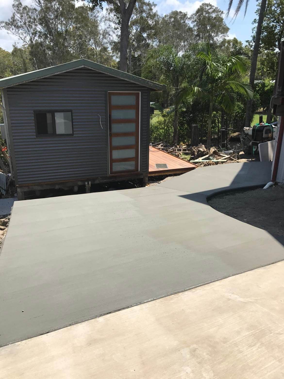Small House Sitting Next To A Concrete Driveway — Providing Steel & Concrete Construction In Eviron, NSW