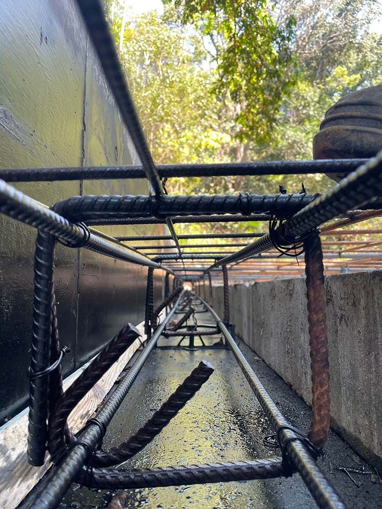 Close Up Of A Metal Structure With Trees In The Background - Providing Steel & Concrete Construction In Byron Bay, NSW