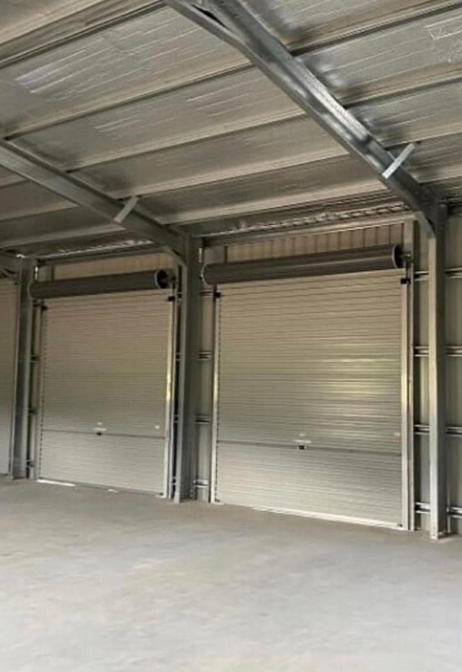 Two Garage Doors in the Warehouse — Providing Steel & Concrete Construction in Gold Coast, QLD