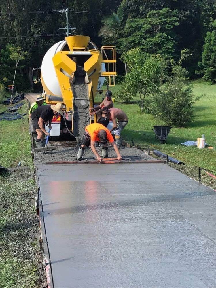 Group Of Construction Workers Are Working On A Concrete Driveway — Providing Steel & Concrete Construction In Eviron, NSW