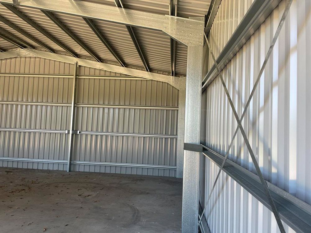A Large Empty Building With A Metal Roof And Walls  —CJR Group Concrete Construction In Tweed Heads, NSW