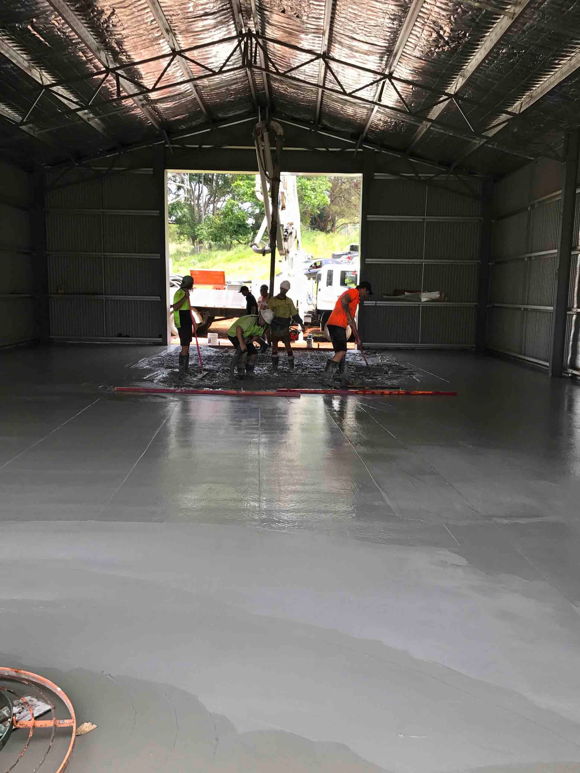 Group Of People Are Working On The Floor Of A Building — Providing Steel & Concrete Construction In Eviron, NSW
